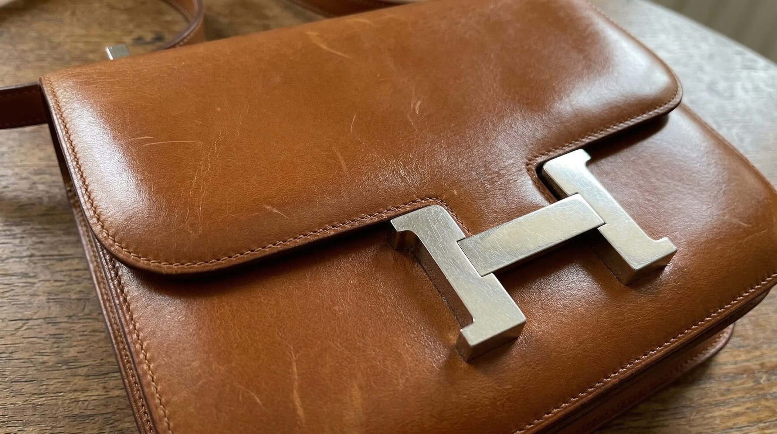 Hermès Constance bag in Barenia leather showing H-clasp and pellicule patina development on envelope flap