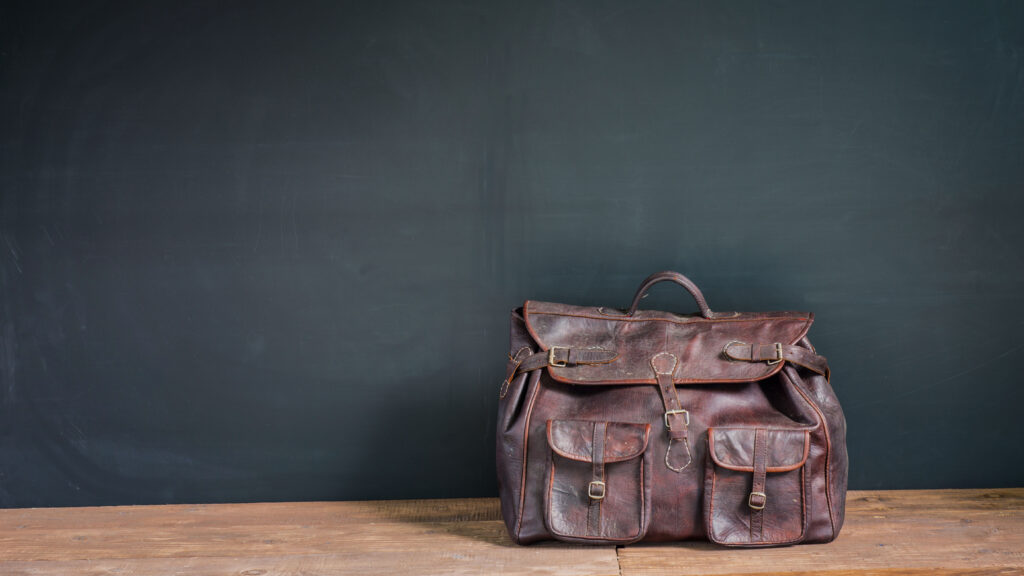 Worn vintage leather handbag showing natural aging and patina over time