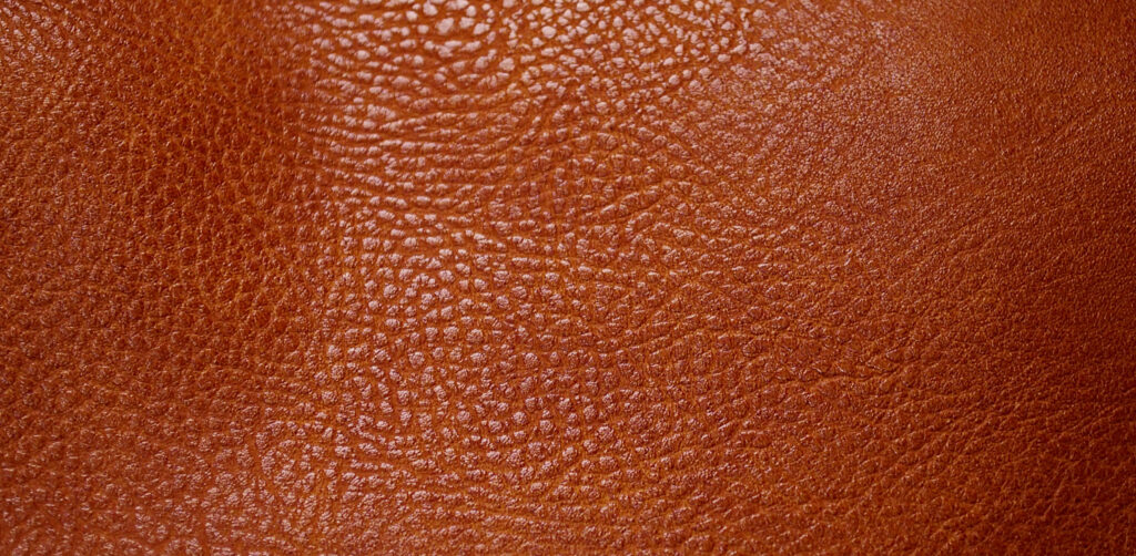 Hermes Barenia Faubourg Patina Progression: Month-by-Month Guide Close-up of warm tan leather grain, illustrating the gradual deepening of tone typical of Barenia Faubourg patina
