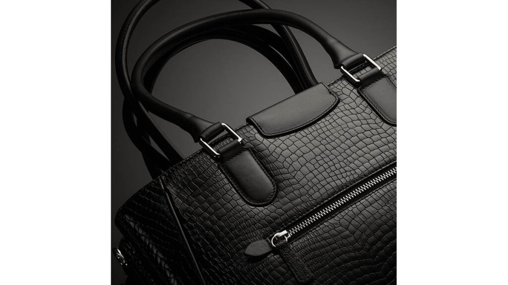 Which Hermes Birkin Leather Wears Best Over 10 Years? Structured leather handbag on a dark background, representing the Birkin leather types compared for long-term wear