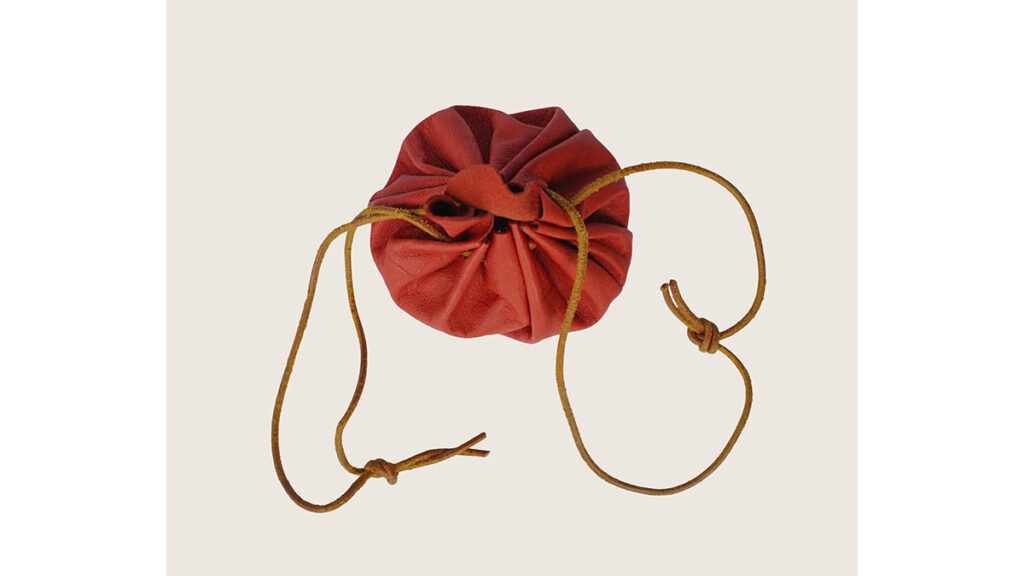 A small leather drawstring bucket-style bag, representing the silhouette compared across Picotin sizes