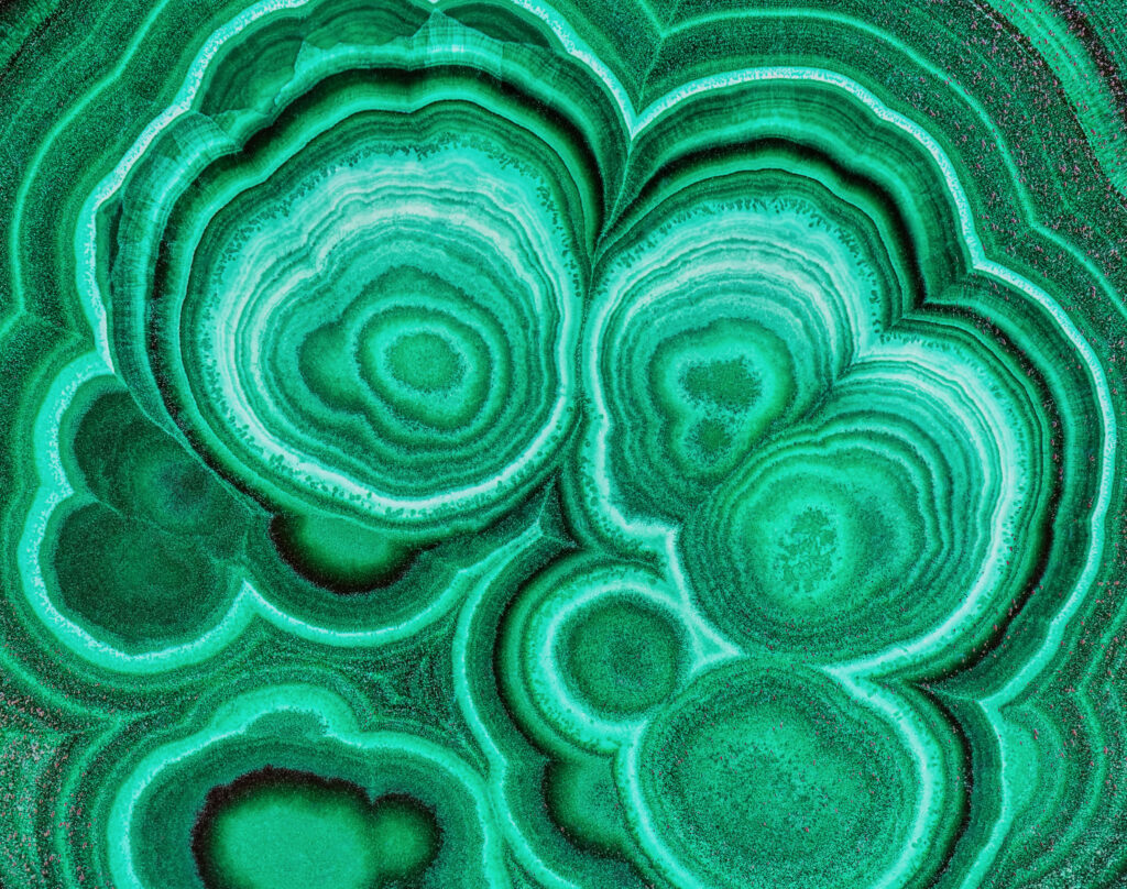What Does “Full Malachite” Mean in Hermès Terminology? Polished malachite mineral with its distinctive banded green pattern, representing what full malachite means in Hermes terminology