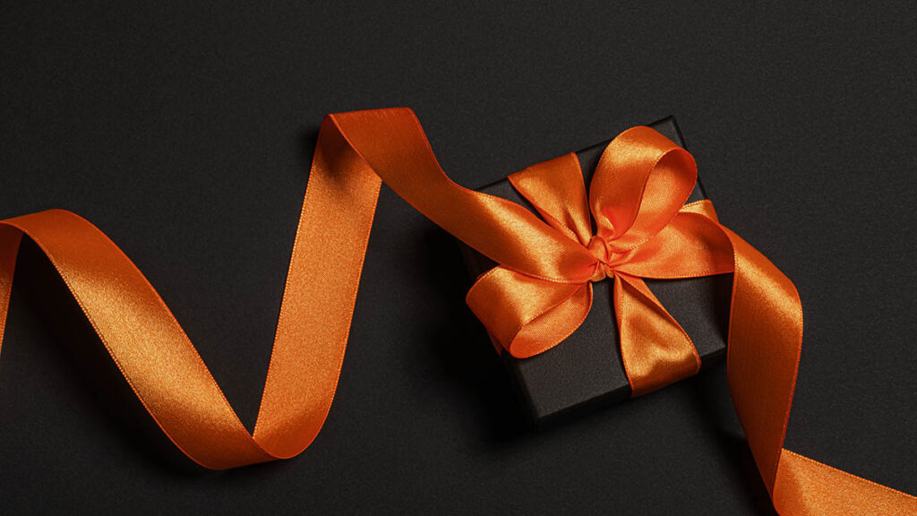 Hermès Box Condition and Papers: How Much Do They Add to Resale? A presentation gift box with ribbon, representing the box and papers that can add to a resale listing's value
