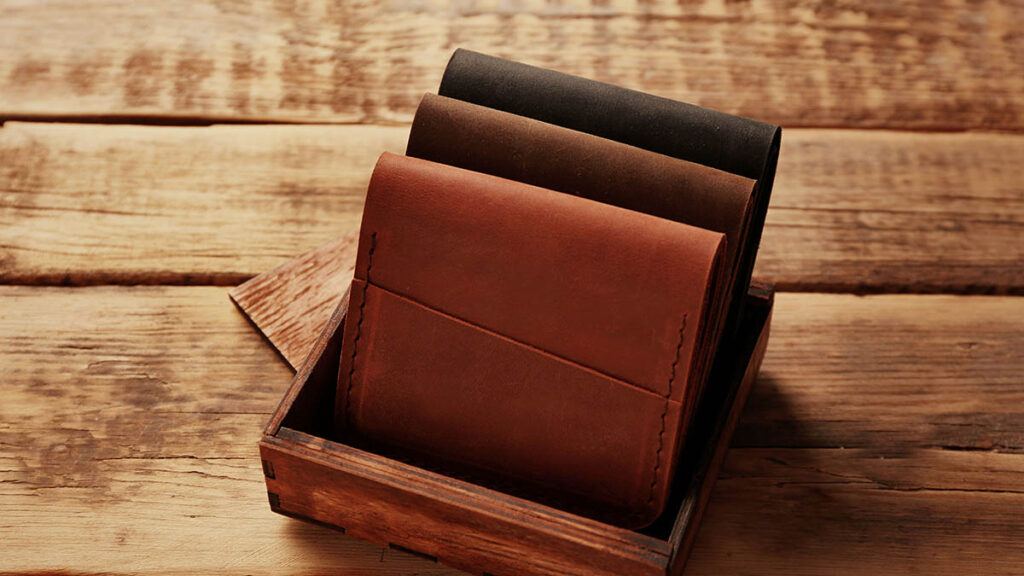 Graduation Gifts: Entry-Level Hermès Pieces Worth Considering Stylish leather wallets presented in a gift box, entry-level luxury accessories