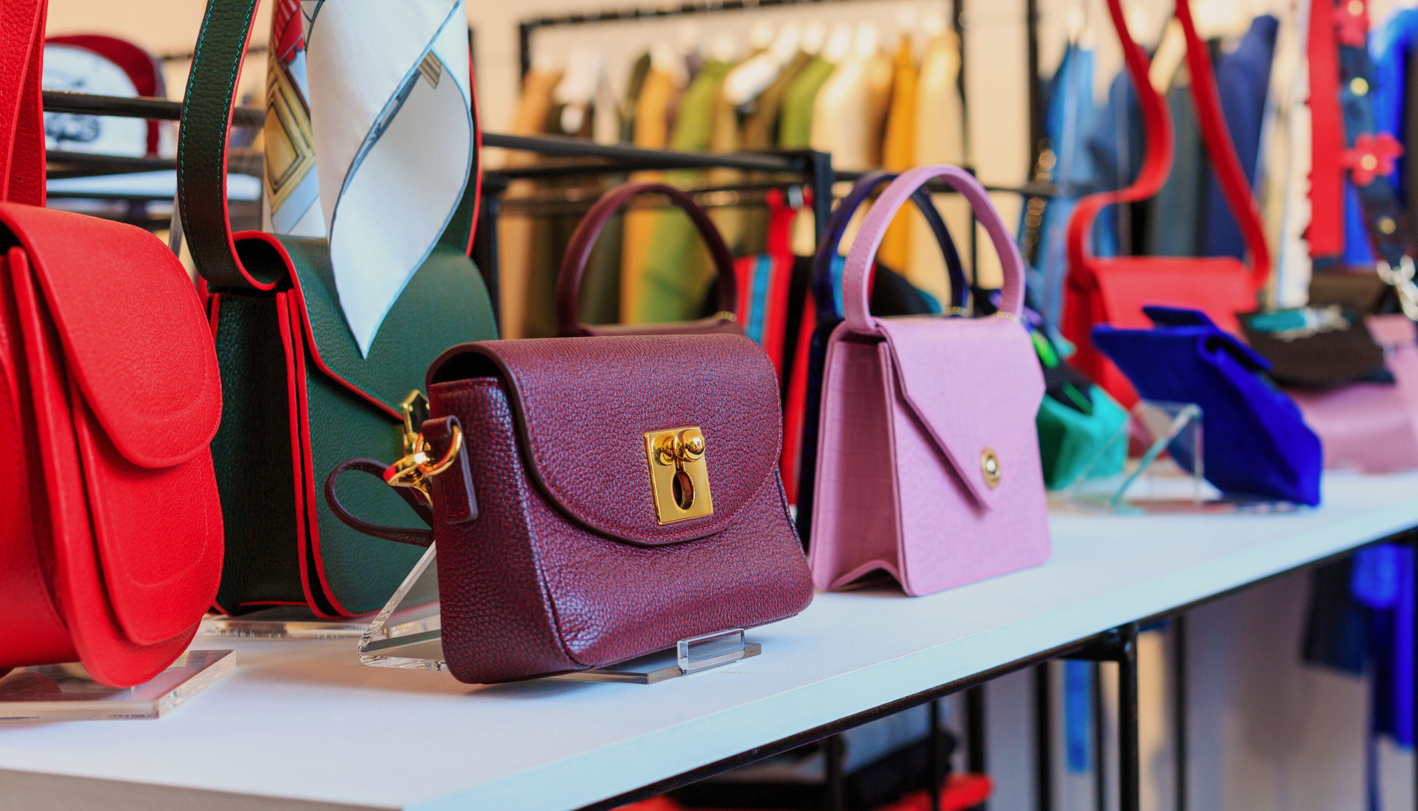 Handbags displayed in a boutique shop window, representing the pieces most likely to appreciate fastest in value