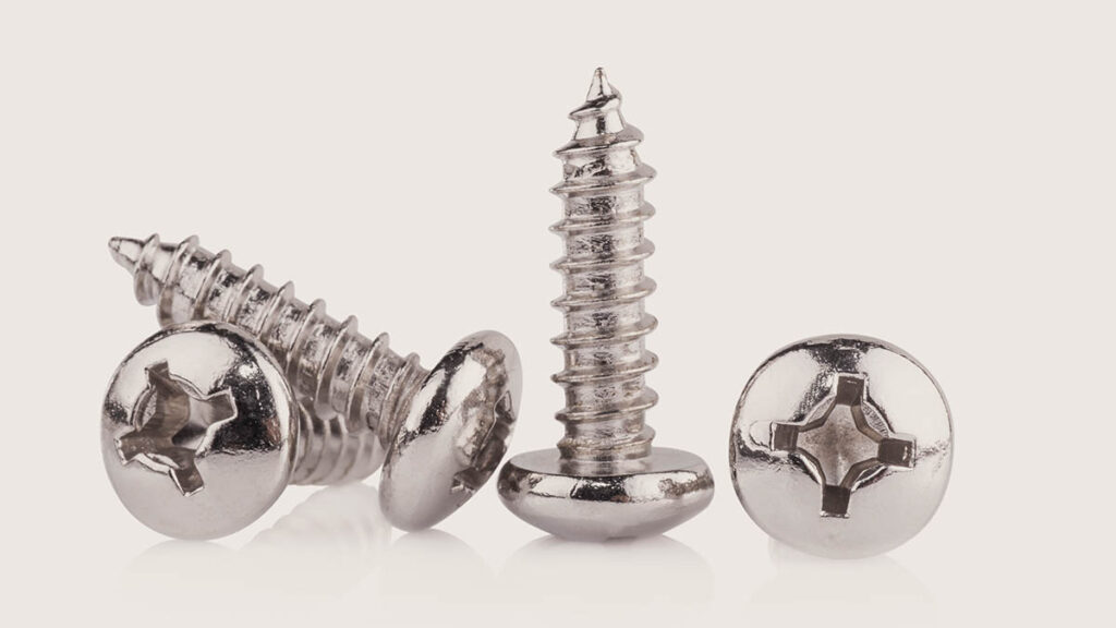 Macro view of a small precision metal screw, illustrating the detail examined when authenticating Hermes hardware screws