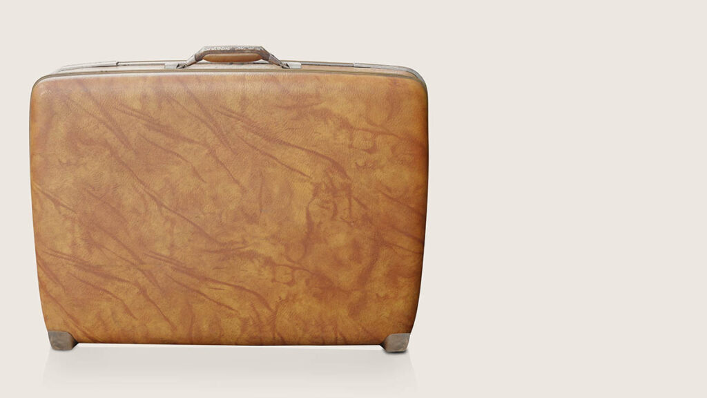 A large structured leather travel bag, representing the scale difference discussed between the Birkin 35 and 40