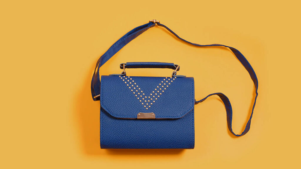 A small leather clutch, representing the flat envelope construction of the Hermes Jige clutch