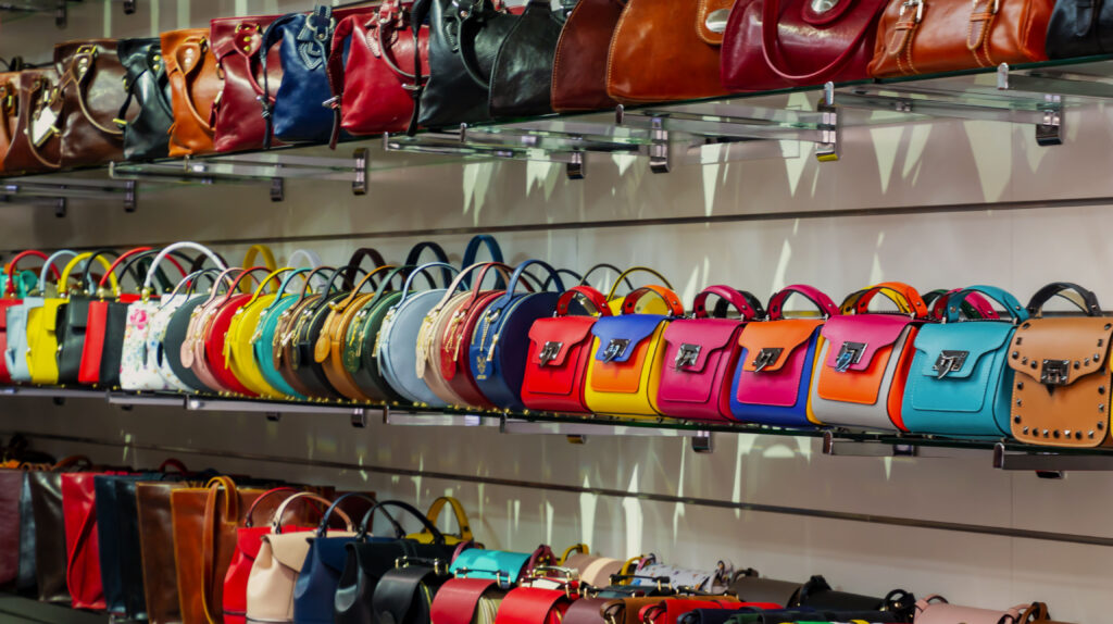 Best Hermès Colors for Everyday Use (Rated by Practicality) Assorted structured leather purses on display, representing the choice between Birkin 25 and Kelly 25 for daily use