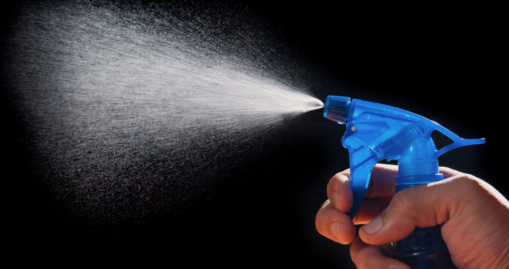 Can You Use Leather Protectant Spray on Hermès Bags? A fine mist sprayed from an atomizer bottle, representing the question of whether protectant spray is safe for Hermes leather