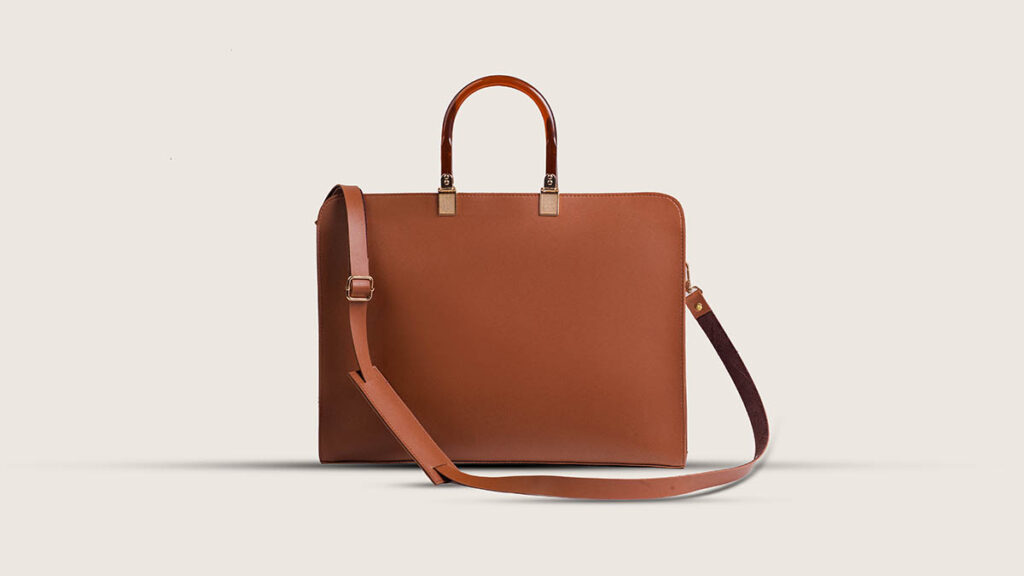 Structured leather handbag with a crisp silhouette, representing the structured format compared against a slouchier bag shape