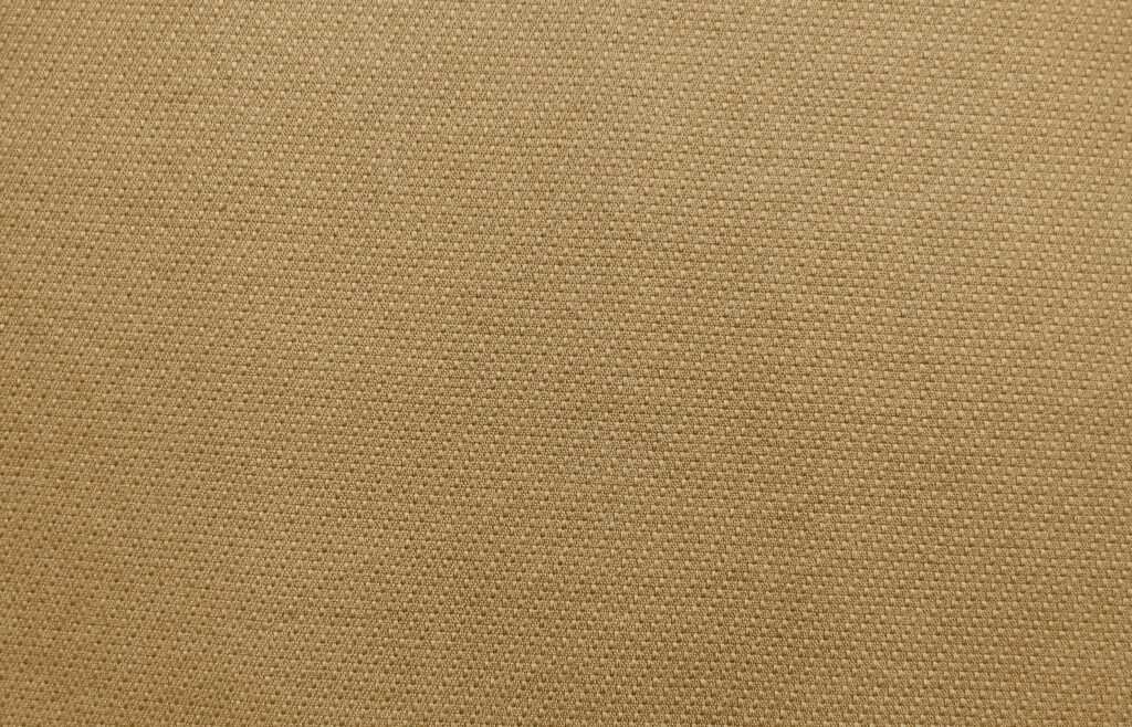 Close-up of woven khaki twill canvas texture, illustrating the toile fabric types used across Hermes canvas pieces