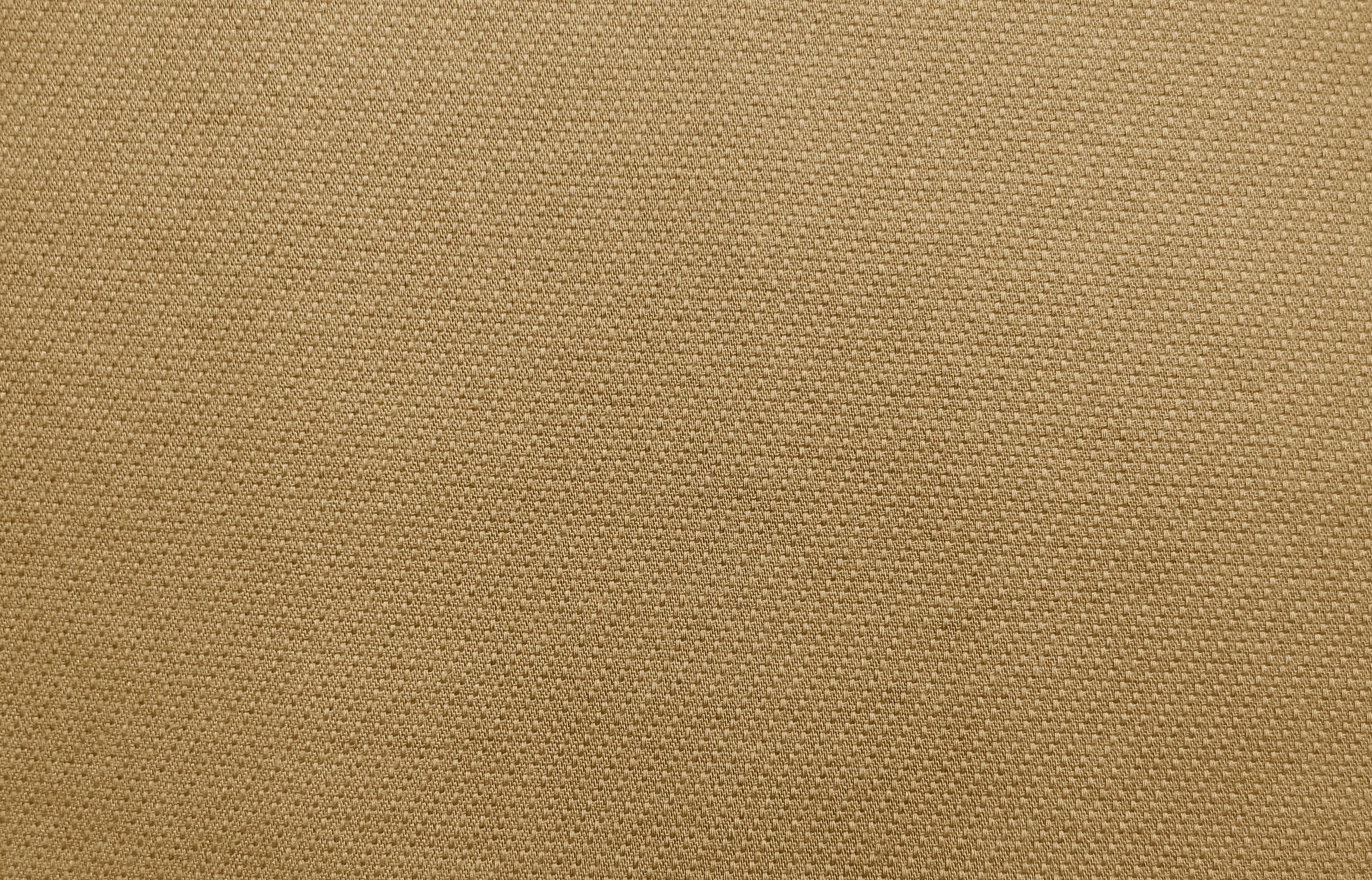 Close-up of woven khaki twill canvas texture, illustrating the toile fabric types used across Hermes canvas pieces