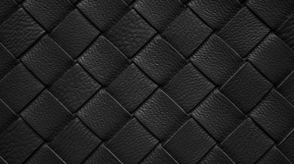 Hermès “Tressage” Explained: What Woven Leather Details Signify Close-up of interlaced woven leather strips, illustrating the hand-woven Tressage technique