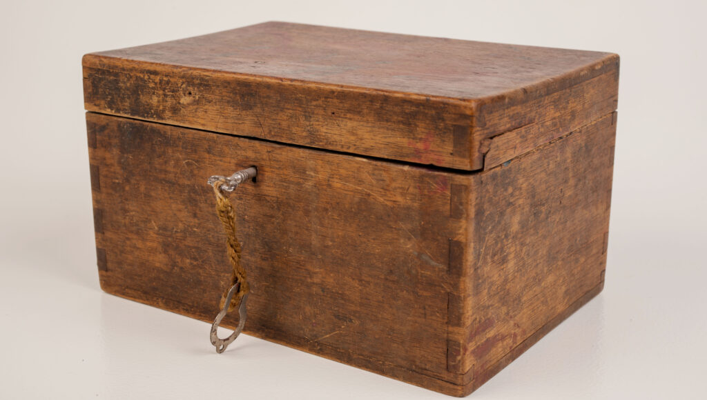 An old wooden case with a small key, evoking the rarity and collectibility of discontinued Hermes bag styles