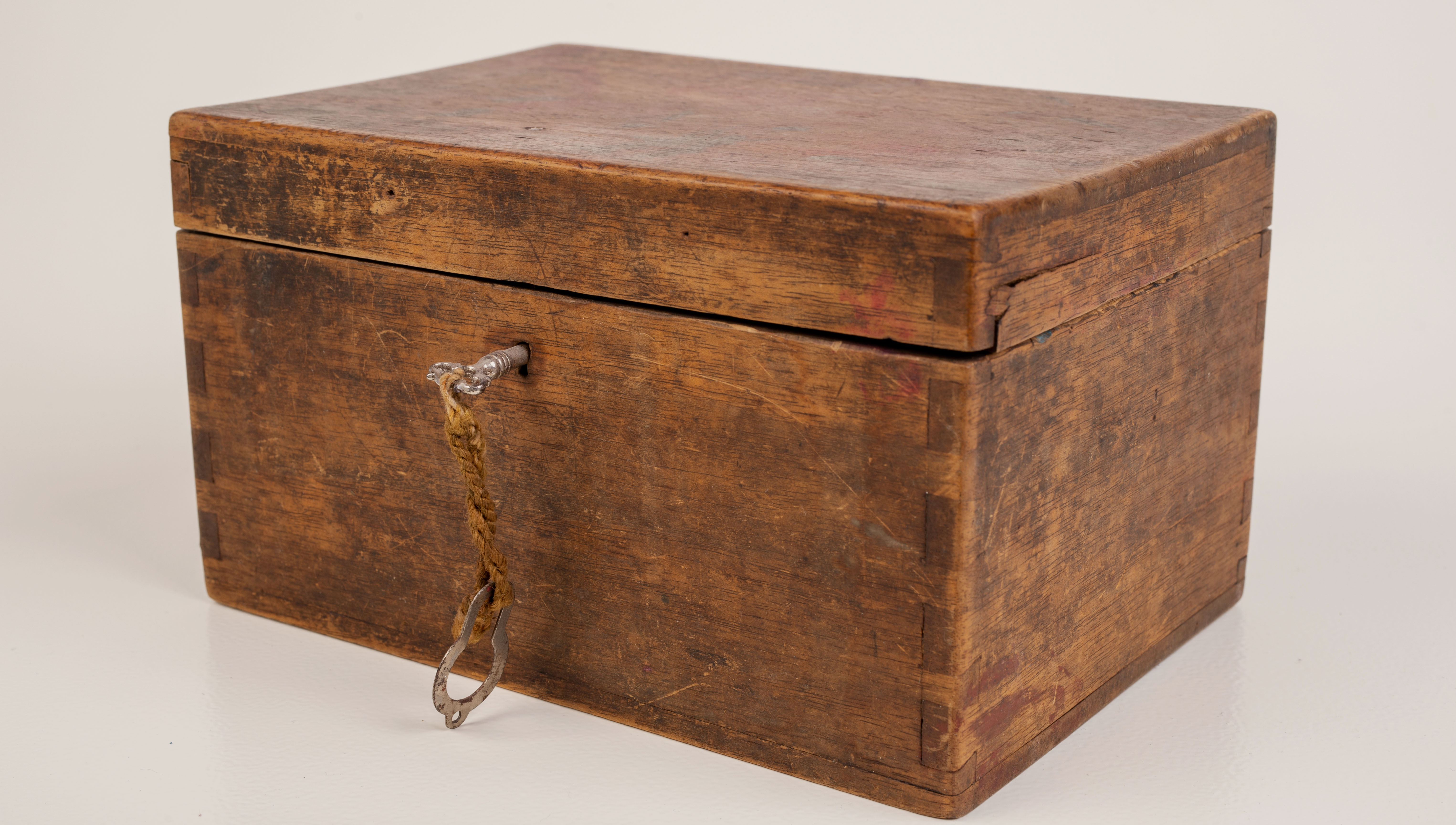 An old wooden case with a small key, evoking the rarity and collectibility of discontinued Hermes bag styles