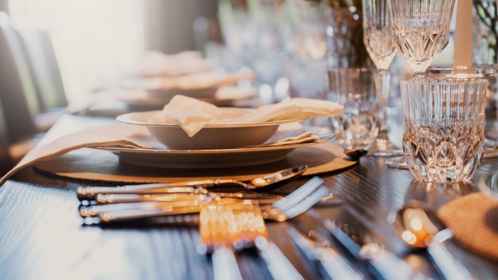 Luxury tableware place setting with silver flatware and crystal glassware